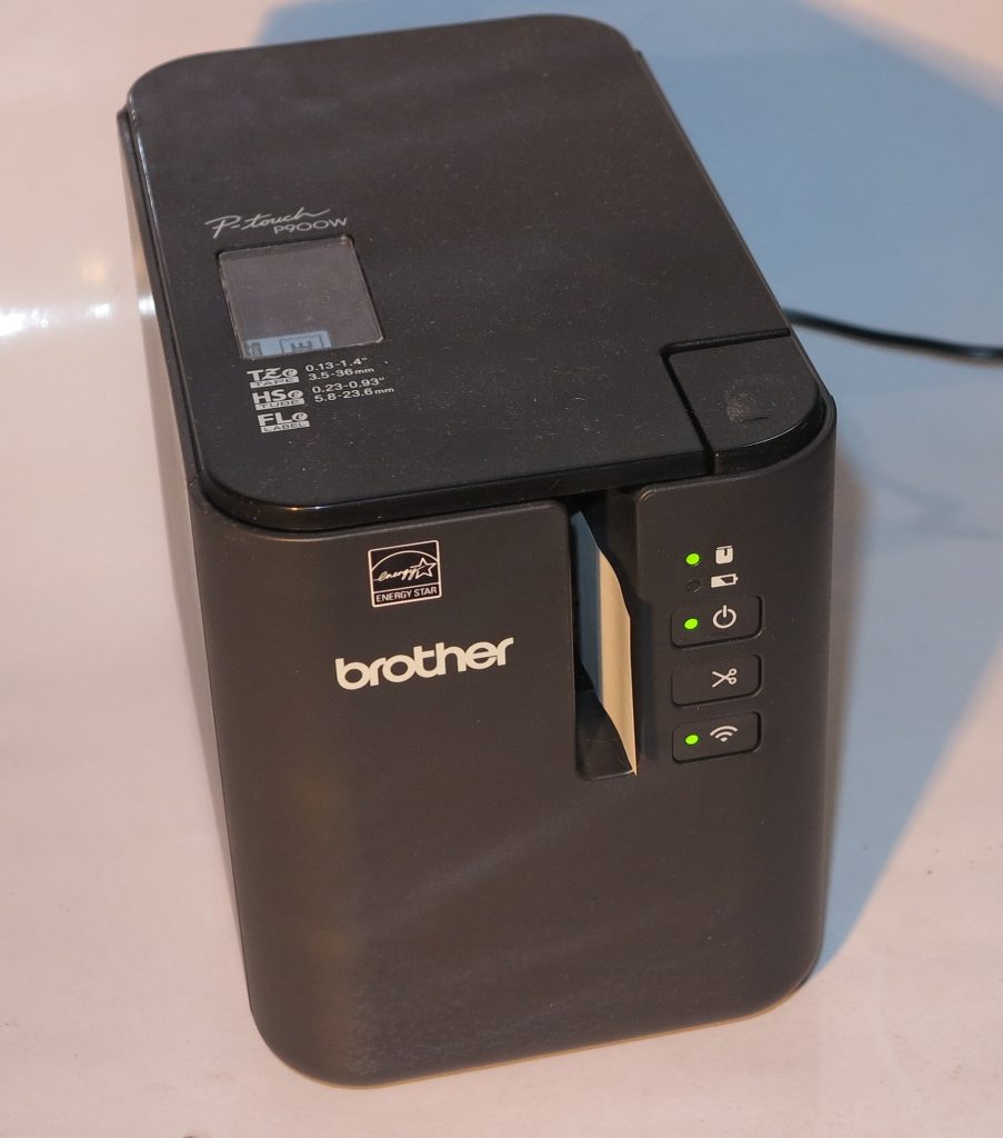 Brother PT-P900W label printer turning out a label