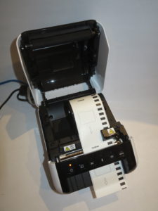 Brother QL-1110NWB network label printer loaded with standard label tape