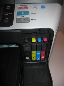 Ink cartridges accessible from front of unit