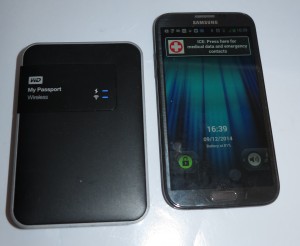 WD MyPassport Wireless mobile NAS beside Samsung Galaxy Note 2 smartphone