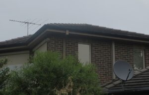 TV aerial and satellite dish on house roof